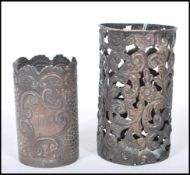 Two silver hallmarked cup / beaker holders to include a repousse effect holder with scrolled rim and