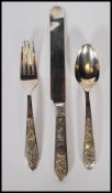 A Chinese silver singular cutlery set consisting on a knife, fork and spoon having floral decoration