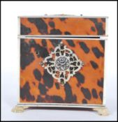 A 19th Century square blond tortoiseshell tea caddy, having ivory diamond lattice panel decoration