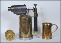 A Georgian 19th Century brass tankard / measure of large form having shaped handle and impressed