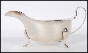 A Viner's silver hallmarked sauce boat having a shaped rim raised on cab feet. Hallmarked