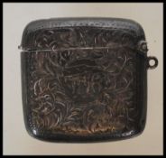 A early 20th Century silver hallmarked vesta case having engraved foliate and swirl decoration