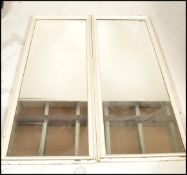 A pair  vintage early 20th century shop / haberdashery mirrors. Of rectangular form having white