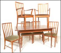 A retro 20th Century teak wood Danish inspired G-Plan style dining suite, the extendable table