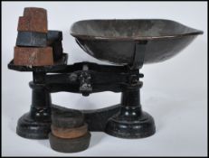 Vintage traditional balance weighing scales. Cast iron with copper bowl plus eleven weights.