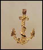 A 9ct gold pendant in the form of an anchor with a