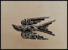 A wonderful silver marcasite and onyx adorned brooch in the form of a swallow bird. Art Deco