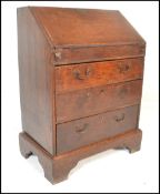An 18th century country oak ladies writing bureau on stand. Of small proportions, the bureau with