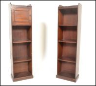 A pair of Edwardian solid mahogany upright pedestal bookcases. Each with plinth bases having open