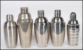 A group of five cocktail shakers of different form