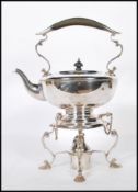 A 20th Century silver plated spirit kettle having a scrolled design handle to the top being raised