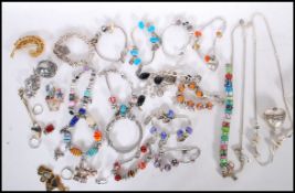 A collection of vintage and contemporary costume jewellery to include various silver charm