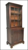 A 19th century Victorian library bookcase cabinet. Raised on shaped bracket feet with locker door