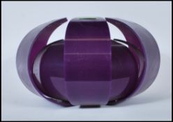 A vintage retro layered shaped ceiling light fixture, constructed from a purple moulded fabric.