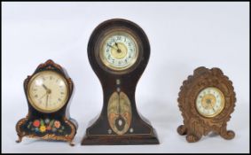 A group of three balloon shaped clocks to include