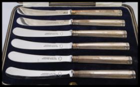 A cased set of silver hallmarked Harrods of London fruit / butter knives complete in the
