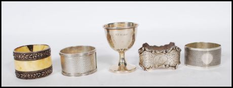 A collection of four silver hallmarked non matching napkin rings together with a silver hallmarked