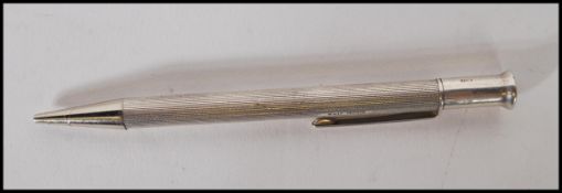 A mid 20th Century William Manton silver hallmarked propelling pencil having engine turned