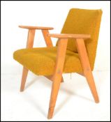 A Danish style retro 20th Century open framed beech wood lounge / fireside armchair, upholstered