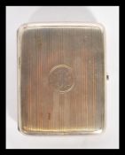 A silver hallmarked cigarette case with engine turned decoration having central monogram.