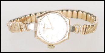 An hallmarked 9ct gold vintage ladies cocktail watch by Vertex, having a silvered dial with arabic