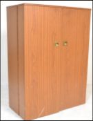 A 1970’s retro cube desk cabinet. Faux teak wood veneers with brass campaign  handles opening to