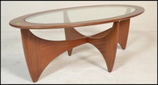 A mid century Victor Wilkins for G-Plan Oval Astro glass top teak coffee table. Lozenge form with