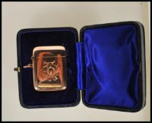 A stamped 375 9ct gold vesta case of square form having central engraved monogram with match striker