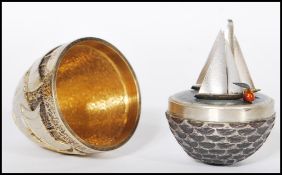 A silver hallmarked Stuart Devlin limited edition surprise egg having a textured exterior