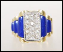 A stamped 18ct gold and diamond ring having blue lapis lazuli stepped shoulders with a pave set