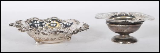 Two early 20th Century silver hallmarked trinket dishes to include a round dish being raised on a