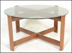 A mid century retro teak wood and smoked glass circular coffee - occasional table. Raised on
