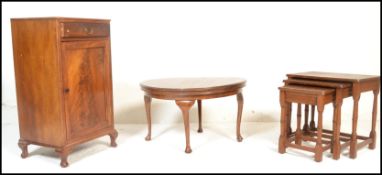 An early 20th century mahogany pedestal cabinet raised on cabriole legs with single drawer over