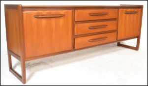 A retro 20th Century G Plan style teak wood sideboard / credenza, flared top over a central bank