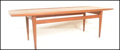 A mid century believed Danish long john coffee / occasional table. Of rectangular form with shaped