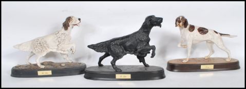 A collection of late 20th century modern Beswick porcelain figurines of dogs ( 3 total ) to