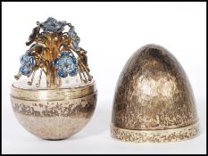 A silver hallmarked Stuart Devlin limited edition surprise egg having a textured exterior opening to