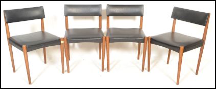 A set of four vintage retro 20th Century Danish dining chairs, faux leather overstuffed seat pad and