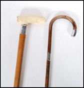 A malacca walking stick cane having a silver collar and bone handle to the top along with a bamboo