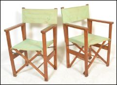 A pair of late 20th century teak wood steamer chairs / garden chairs that fold up and extend