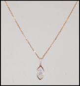 An 18ct yellow gold pear shaped diamond necklace pendant being set to an 18ct gold back chain, the