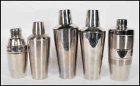 A group of five cocktail shakers of different form