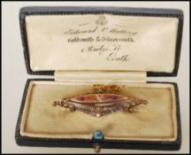 A 19th Century Victorian hallmarked 15ct gold mourning bar brooch having a central diamond flanked