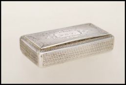A 20th Century continental silver snuff box of rectangular form having engine turned decoration with