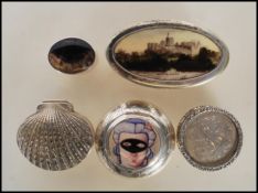 A collection of silver and silver plated pill boxes to include a stamped 925 silver shell box, a