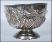 A late Victorian silver hallmarked rose bowl with scalloped decoration being raised on a terraced