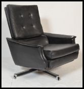 A retro 20th century 1960's black swivel recliner