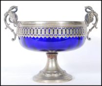 A late 19th Century Victorian silver plated twin handled pedestal bowl having a blue glass liner,