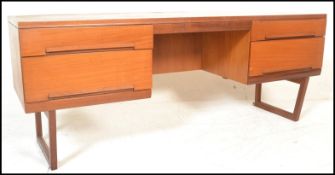 A retro 20th Century teak wood twin pedestal kneehole desk, having a configuration of drawers raised