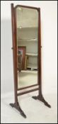 An Edwardian mahogany cheval - ladies full length bedroom dressing mirror. Raised on a mahogany